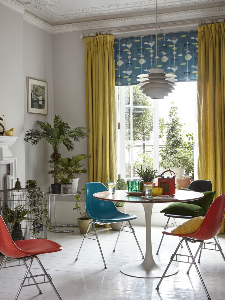 This is an example of a retro dining room in London with grey walls and white floors.