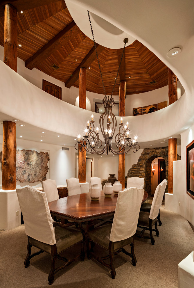 Example of a southwest beige floor dining room design in Phoenix with white walls