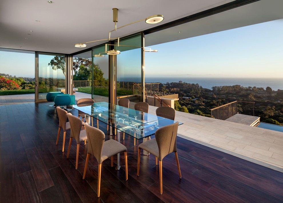 This is an example of a contemporary open plan dining room in Santa Barbara with dark hardwood flooring.