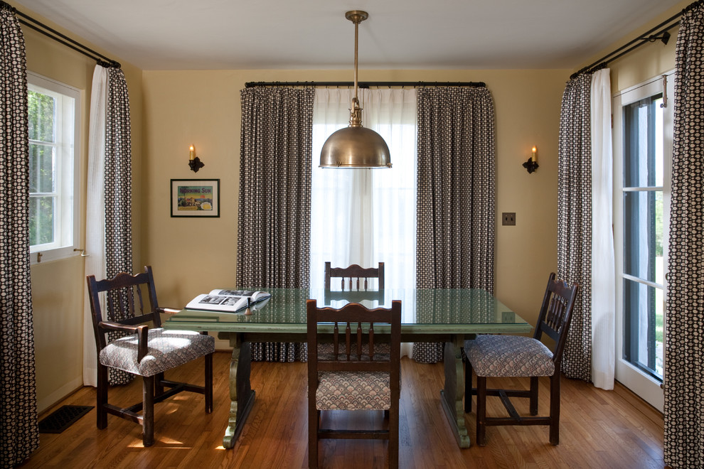 Example of a tuscan dining room design in Santa Barbara with yellow walls