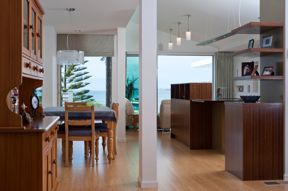 Пример оригинального дизайна: кухня-столовая среднего размера в современном стиле с белыми стенами и полом из бамбука без камина