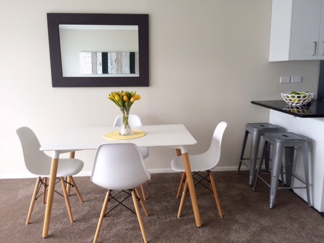 Inspiration for a small modern kitchen/dining room in Auckland with carpet and no fireplace.