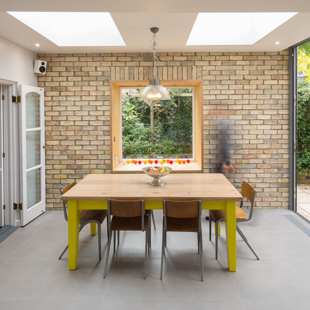 This is an example of a contemporary enclosed dining room in Cambridgeshire with yellow walls.