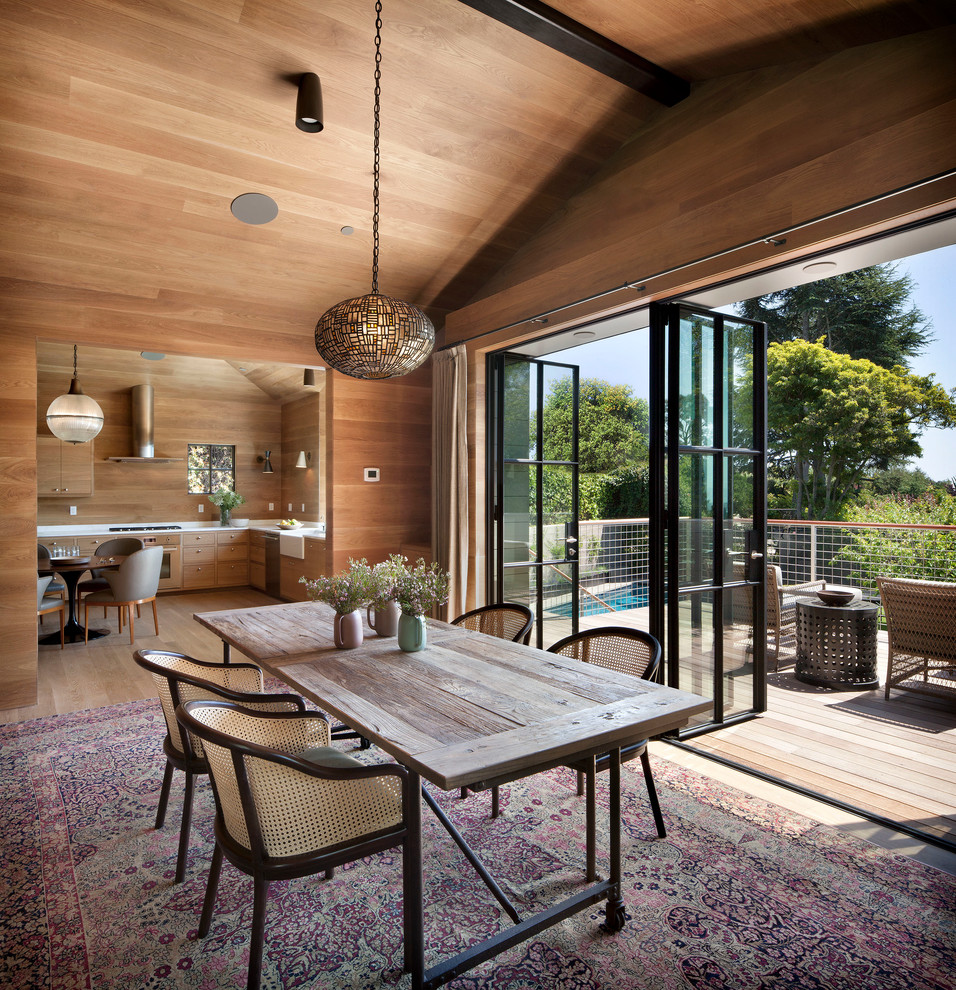 This is an example of a contemporary enclosed dining room in San Francisco with light hardwood flooring.