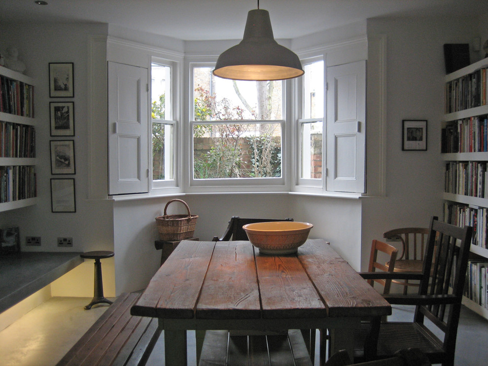 Eclectic dining room photo in London with white walls