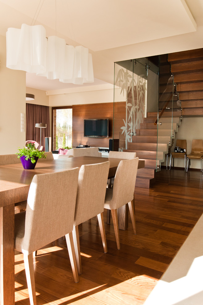 Inspiration for a modern dining room in Other with white walls and dark hardwood flooring.