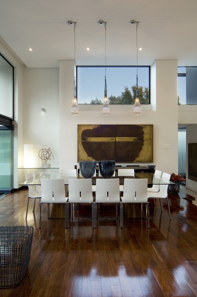 Inspiration for a contemporary dark wood floor dining room remodel with white walls