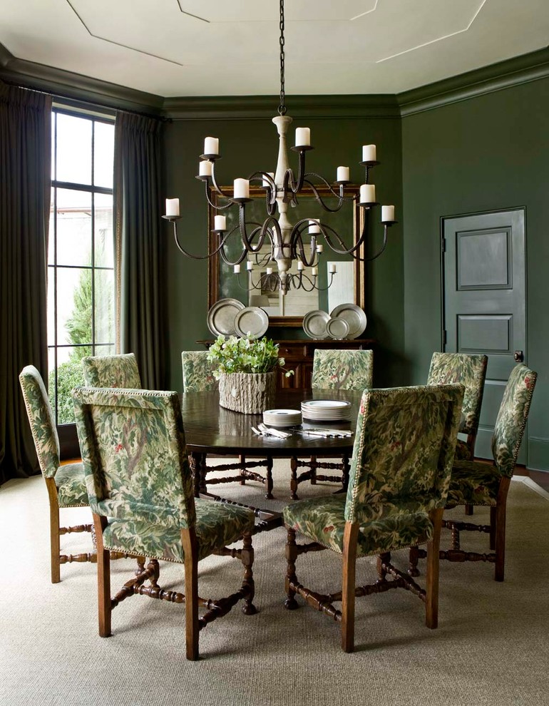 This is an example of a traditional dining room in Atlanta with green walls and beige floors.