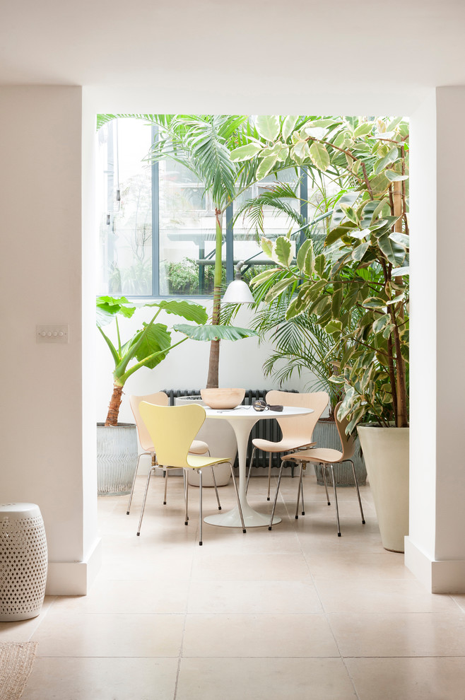 Inspiration for a contemporary beige floor dining room remodel in London with white walls