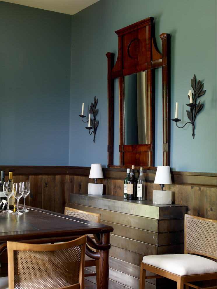 Cette image montre une salle à manger traditionnelle fermée et de taille moyenne avec un mur bleu et parquet foncé.