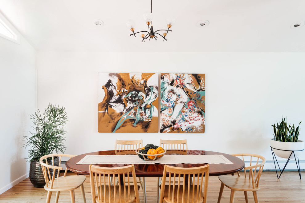 Inspiration for a mid-century modern light wood floor dining room remodel in New York with white walls and no fireplace