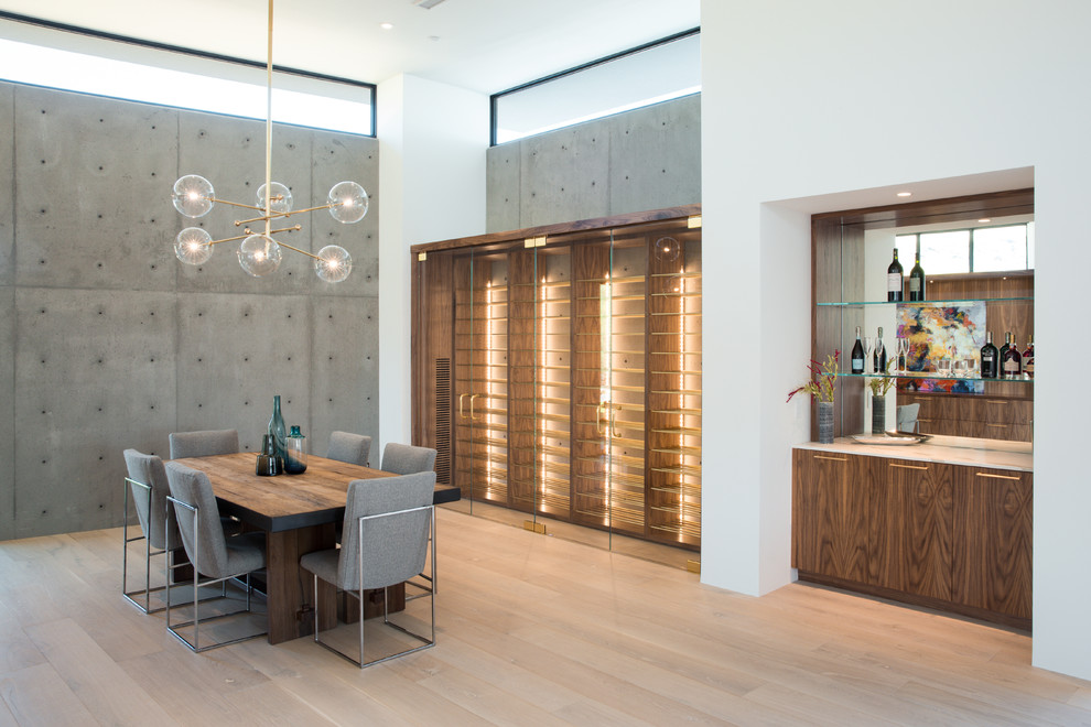 Large modern open plan dining room in Phoenix with light hardwood flooring.