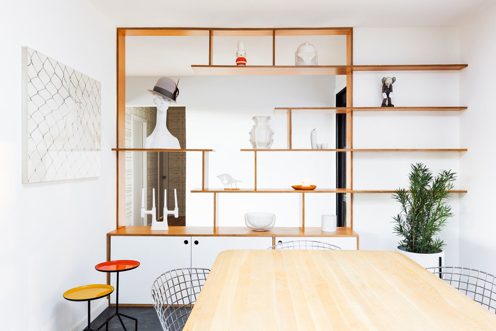 На фото: кухня-столовая среднего размера в стиле ретро с белыми стенами, бетонным полом и серым полом без камина с