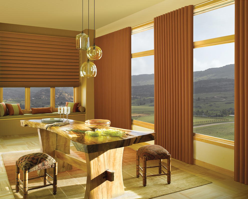 Example of a large mountain style laminate floor and beige floor dining room design in Denver with beige walls