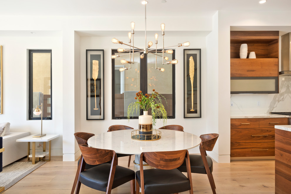 Inspiration for a mid-sized contemporary light wood floor and beige floor great room remodel in Orange County with white walls and no fireplace
