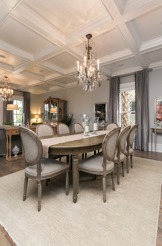 Elegant medium tone wood floor dining room photo in Charleston with gray walls and no fireplace