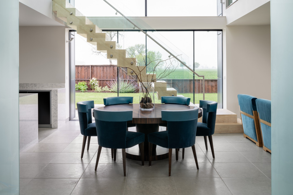 This is an example of a large contemporary open plan dining room in Other with white walls, porcelain flooring and grey floors.