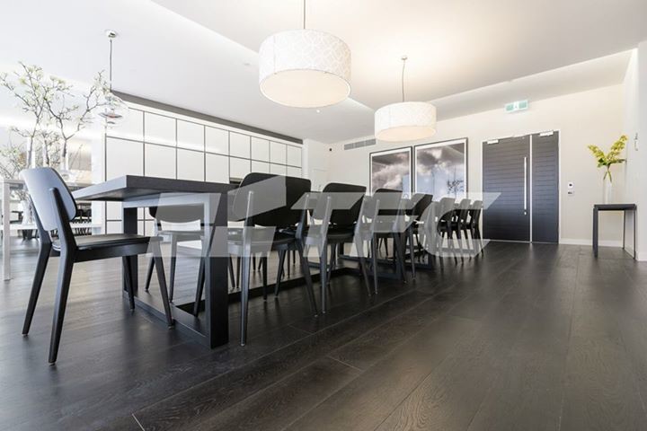 Photo of a large modern kitchen/dining room in Melbourne with black walls.