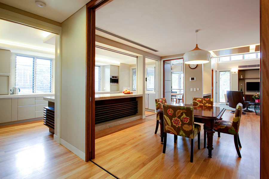 Photo of an expansive contemporary dining room in Brisbane with beige walls, light hardwood flooring, no fireplace and brown floors.