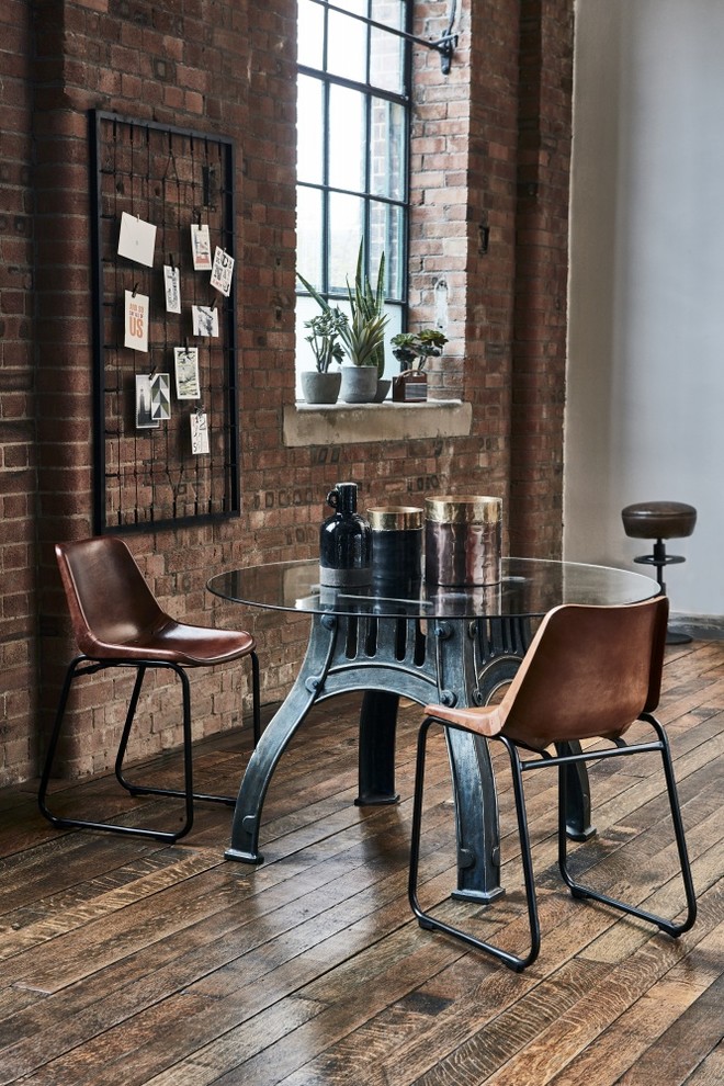 Design ideas for an industrial dining room in Other with grey walls, medium hardwood flooring and brown floors.
