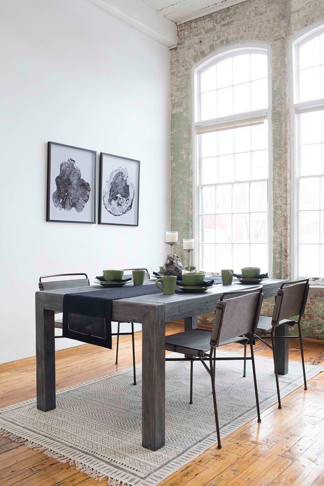 Example of an urban light wood floor dining room design in Boston with white walls and no fireplace