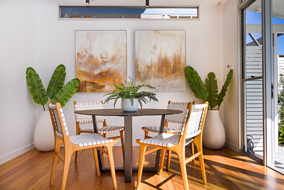Inspiration for a mid-sized tropical medium tone wood floor and brown floor breakfast nook remodel in Brisbane with white walls