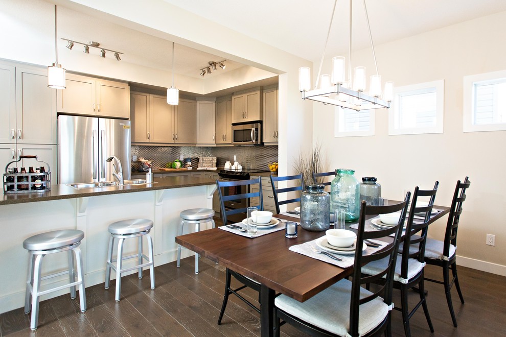 Traditional kitchen/dining room in Edmonton with beige walls and dark hardwood flooring.