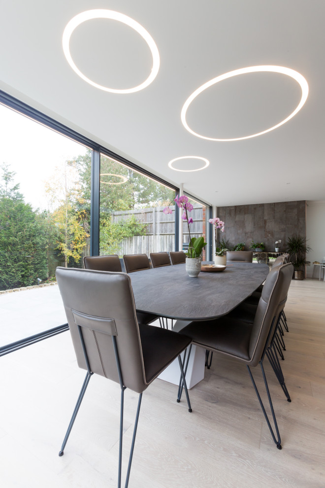 Photo of a large contemporary dining room in London with medium hardwood flooring.