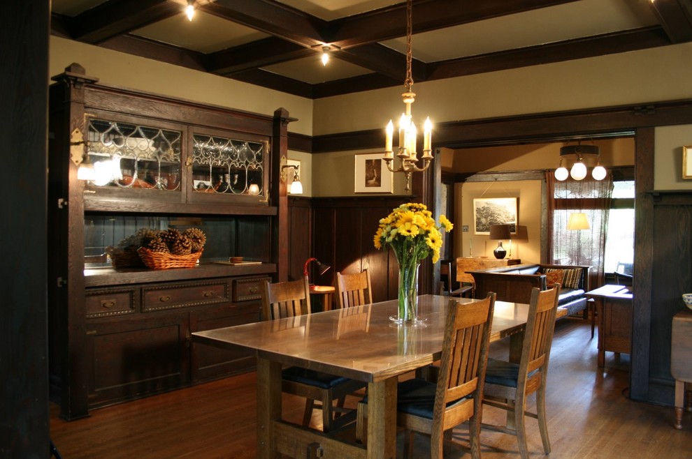 Immagine di una grande sala da pranzo stile americano chiusa con pareti beige, pavimento in legno massello medio e nessun camino