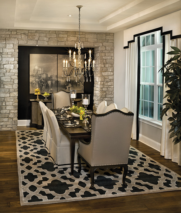 Mid-sized trendy medium tone wood floor enclosed dining room photo in Tampa with beige walls and no fireplace