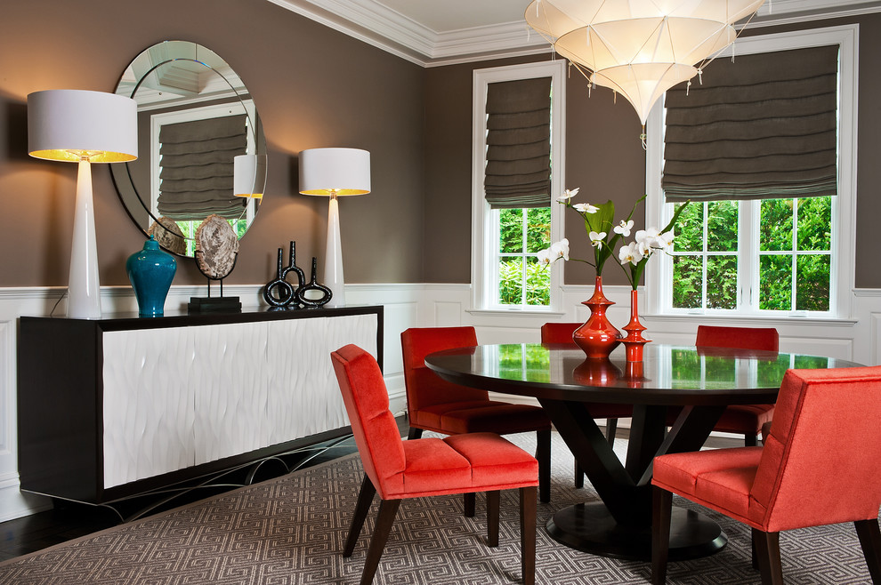Photo of a contemporary dining room in New York with brown walls and feature lighting.