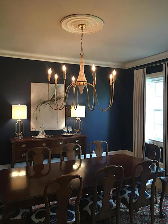Example of a mid-sized classic dark wood floor and brown floor enclosed dining room design in New Orleans with blue walls and no fireplace