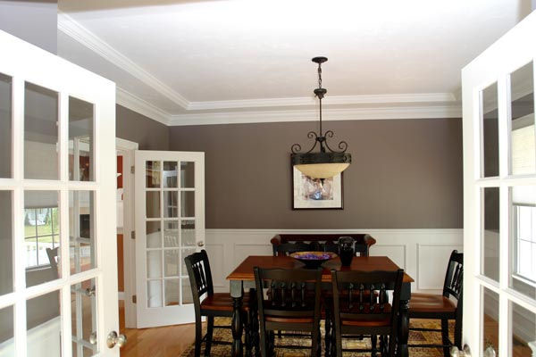 Enclosed dining room - large traditional medium tone wood floor enclosed dining room idea in Boston with gray walls