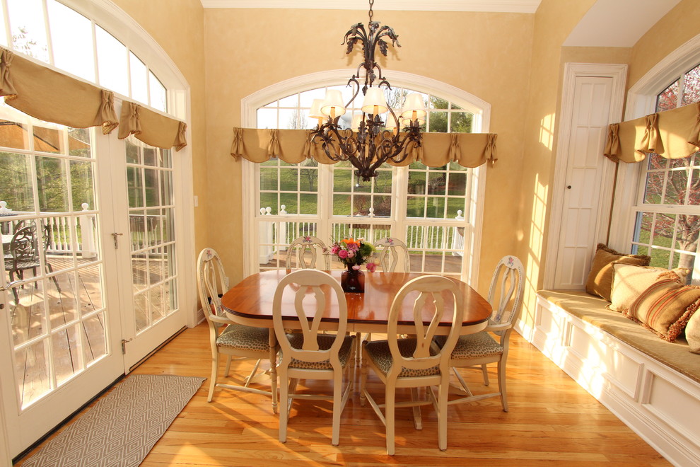 Elegant medium tone wood floor dining room photo in St Louis with beige walls