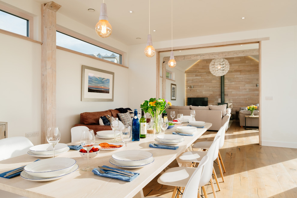 Example of a beach style dining room design in Cornwall