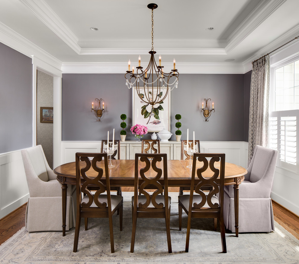 Example of a classic medium tone wood floor enclosed dining room design in DC Metro with gray walls