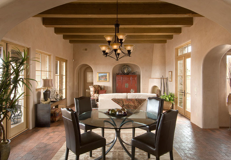 Medium sized rustic dining room in Albuquerque with brick flooring, no fireplace, beige walls and brown floors.
