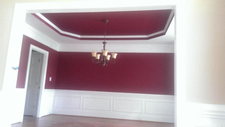 Photo of a dining room in Charlotte with red walls and medium hardwood flooring.