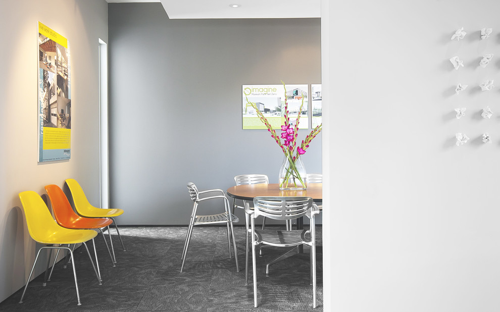Inspiration for a modern carpeted dining room remodel in Houston with gray walls