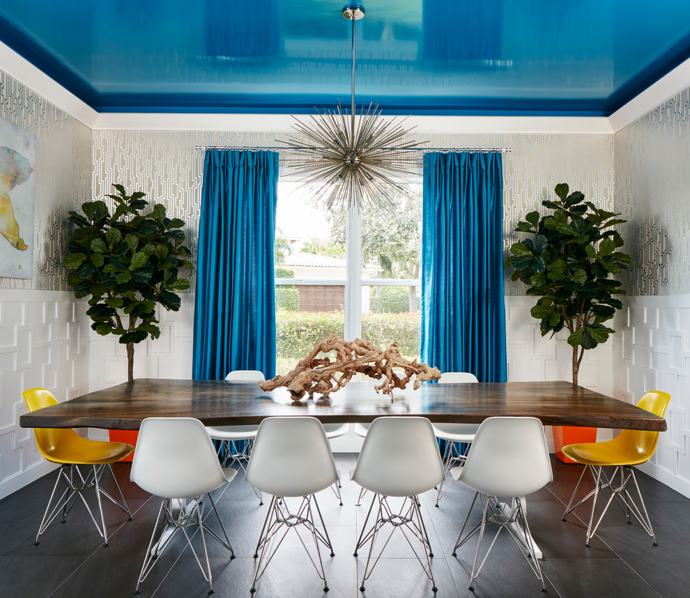 This is an example of a contemporary dining room in Miami with metallic walls and no fireplace.