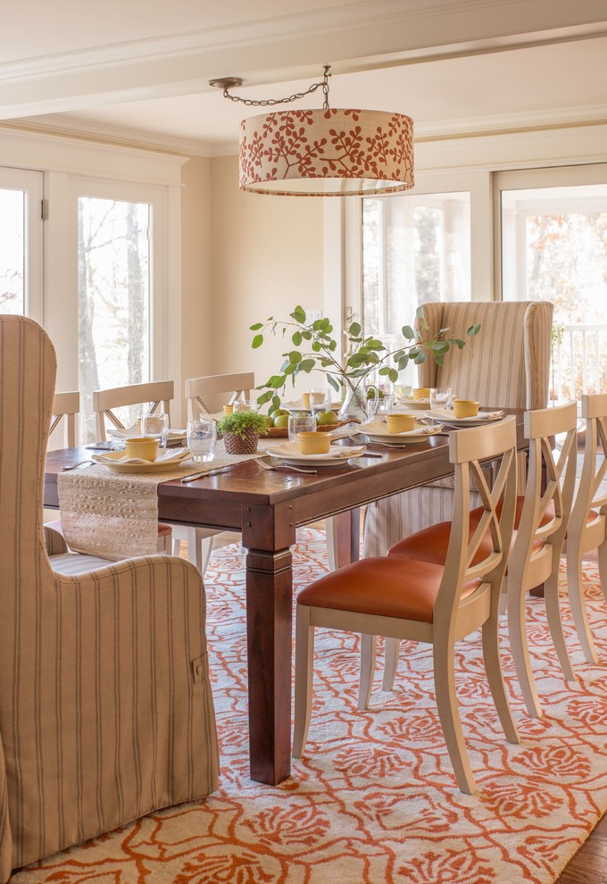 Cette image montre une grande salle à manger ouverte sur la cuisine traditionnelle avec un sol en bois brun.