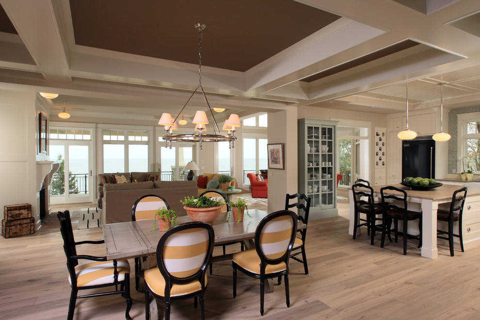 Photo of a large classic open plan dining room in Grand Rapids with light hardwood flooring.