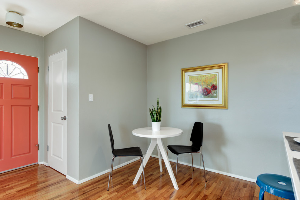 Example of a small minimalist light wood floor great room design in San Diego with gray walls and no fireplace