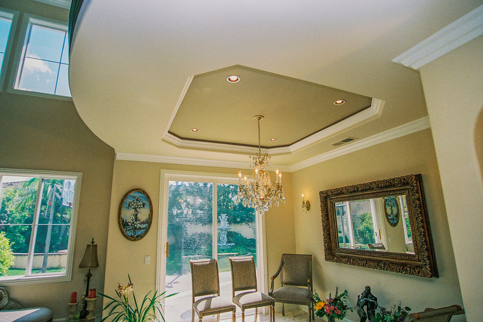 This is an example of a medium sized classic open plan dining room in Orange County with beige walls.