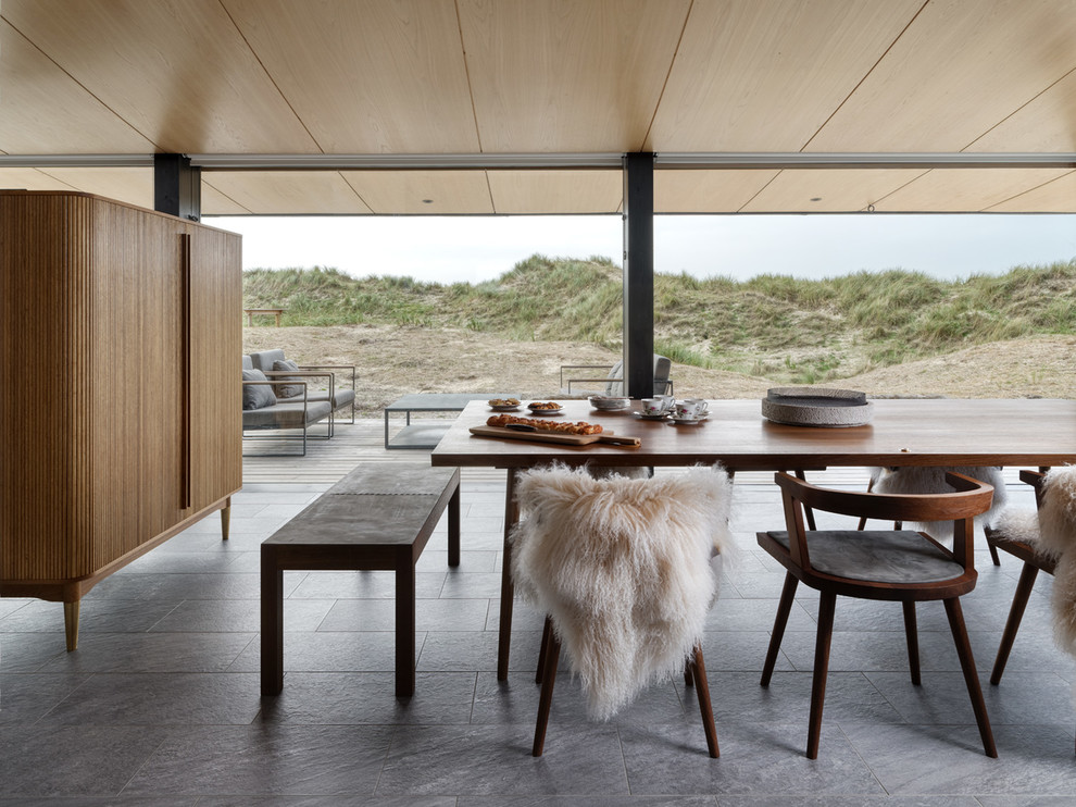 This is an example of a medium sized scandinavian open plan dining room in Other with porcelain flooring and grey floors.