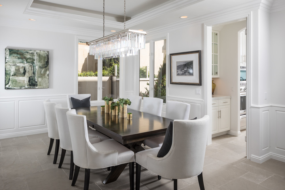 Inspiration for a mediterranean enclosed dining room in Orange County with white walls and grey floors.