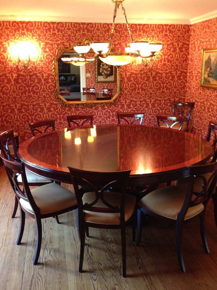 Design ideas for a medium sized classic enclosed dining room in New York with red walls and dark hardwood flooring.