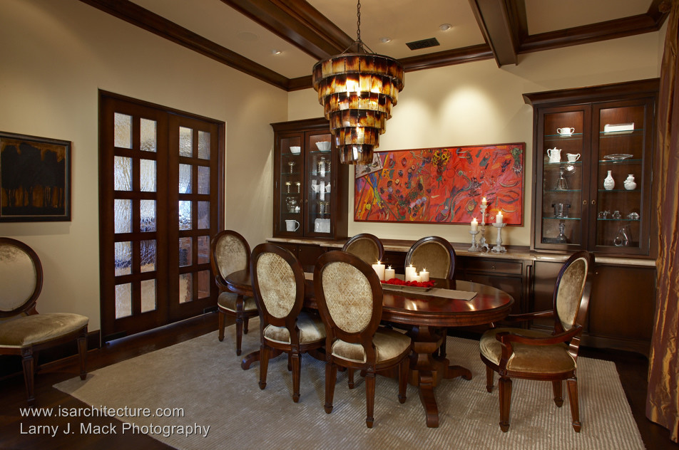 This is an example of a mediterranean dining room in San Diego with beige walls and dark hardwood flooring.