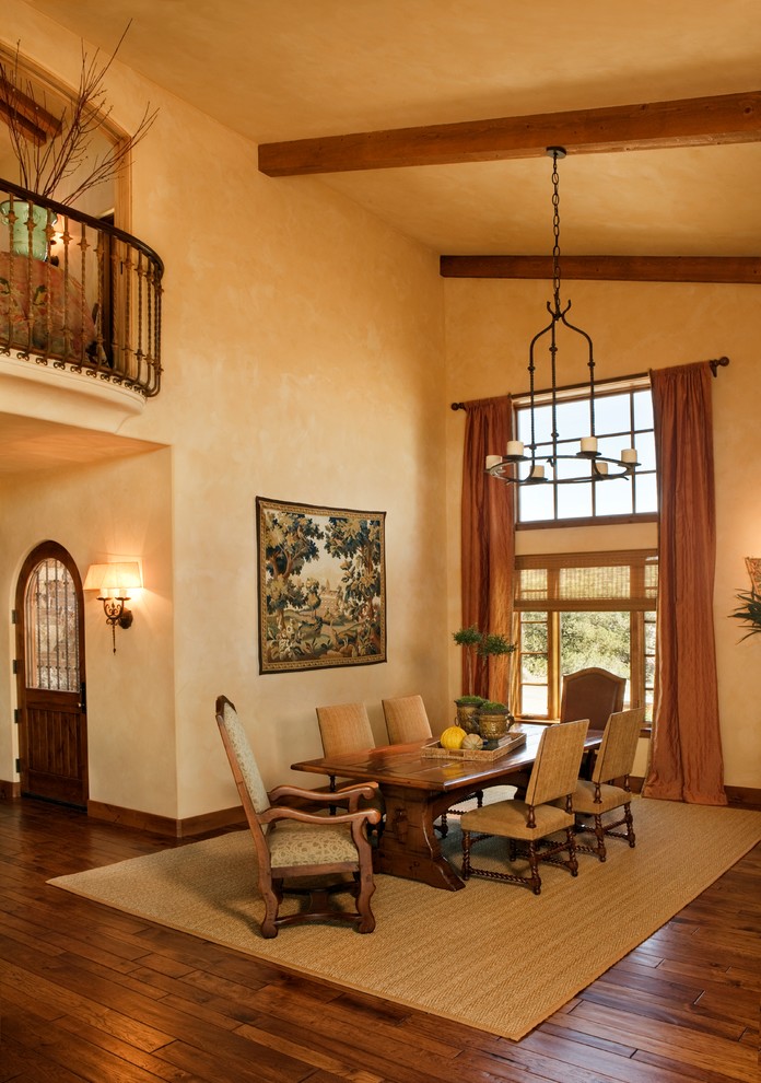 Large tuscan dark wood floor and brown floor enclosed dining room photo in Other with beige walls and no fireplace