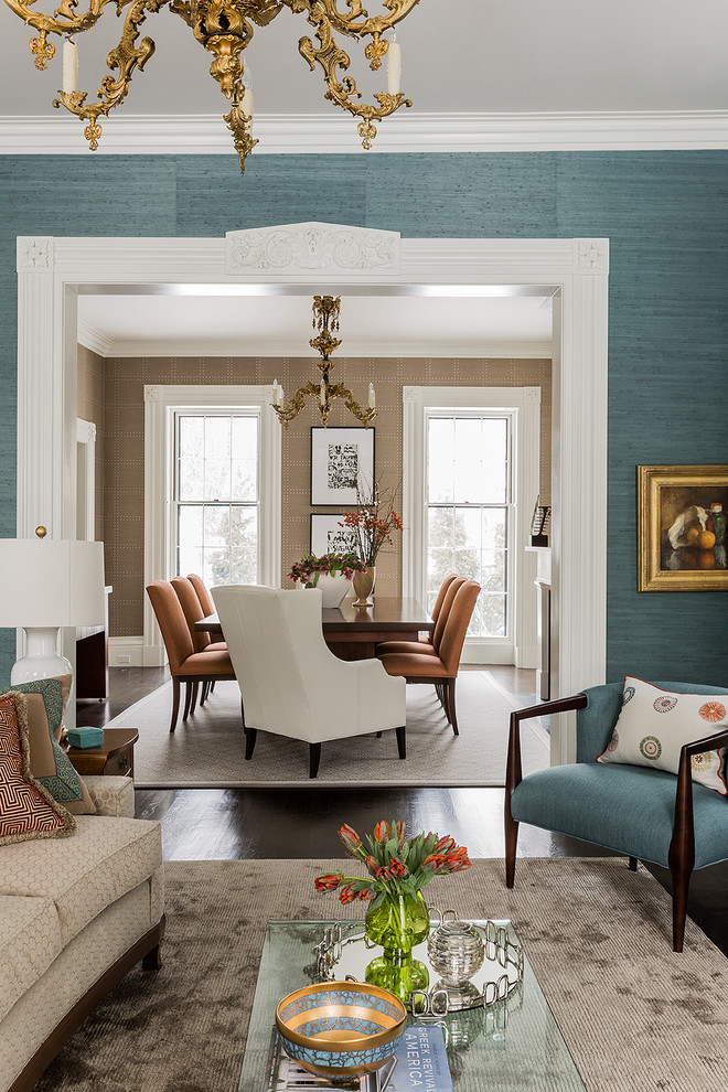 Traditional dining room in Boston with blue walls, dark hardwood flooring and feature lighting.